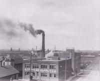 View of factory with smoke coming out of smokestack